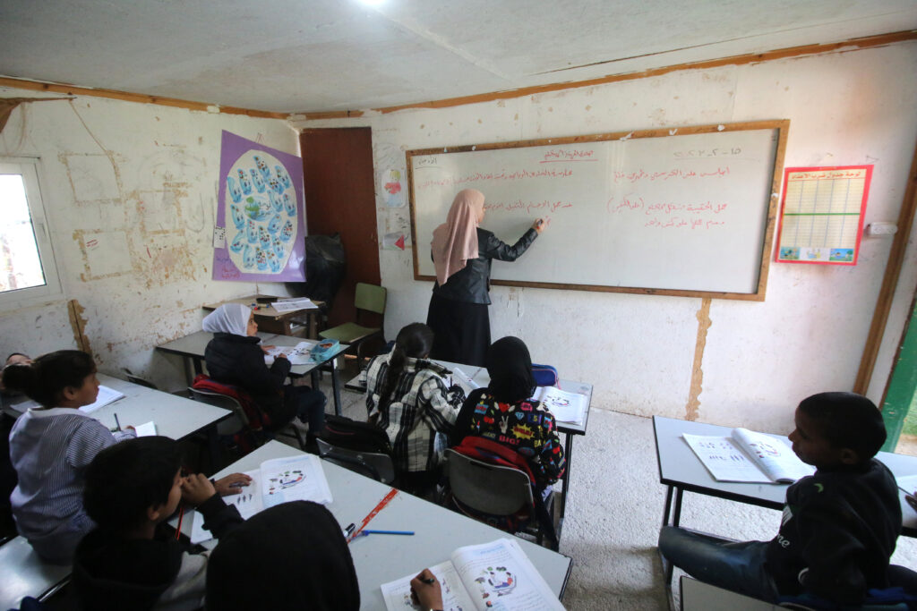 A teacher and students in a classroom at the Khan al-Ahmar school in the West Bank / credit: Ahmad Al-Bazz
